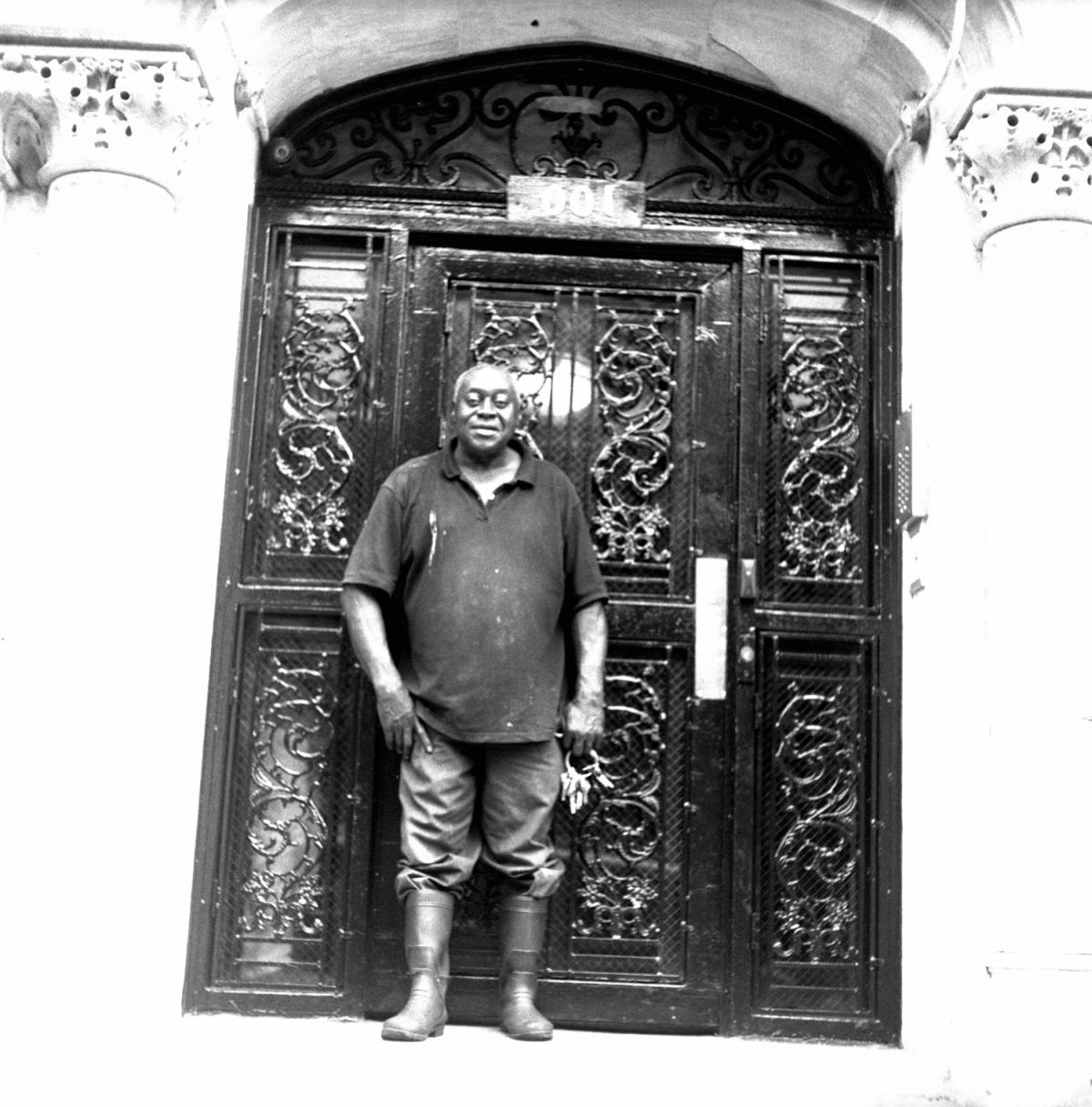 Black man standing in front of building
