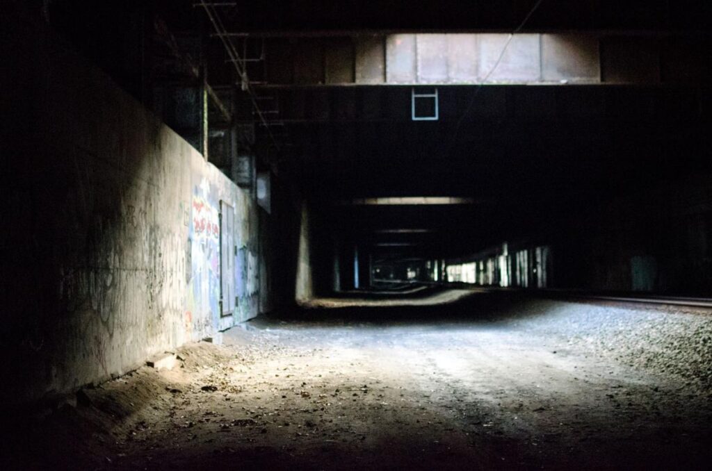 Dark hall in underpass dim light, empty